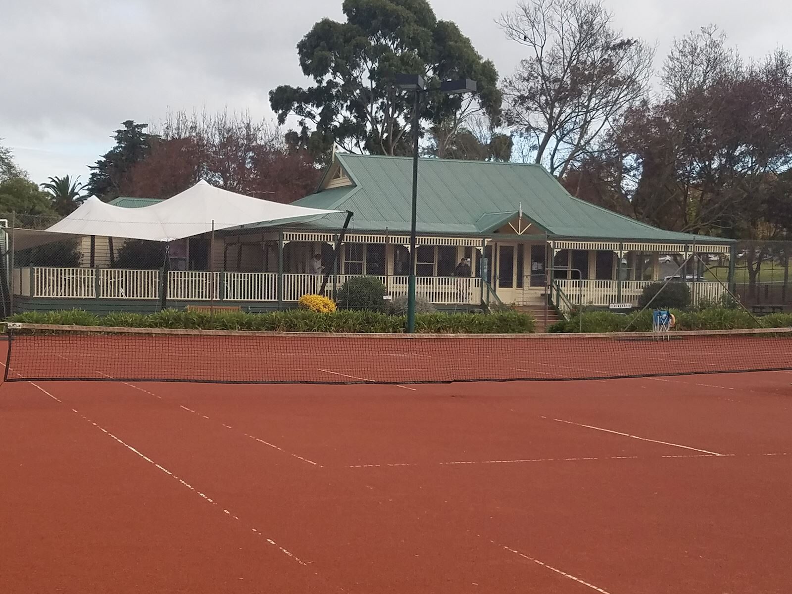 The East Camberwell Tennis Club clubhouse and deck seen across the courts